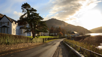 The Arrochar main road, with the Arrochar Hotel on the left, and sunset over Loch Long on the right.