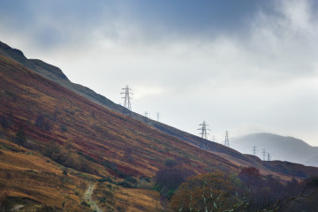 Modern power line towers on a slope